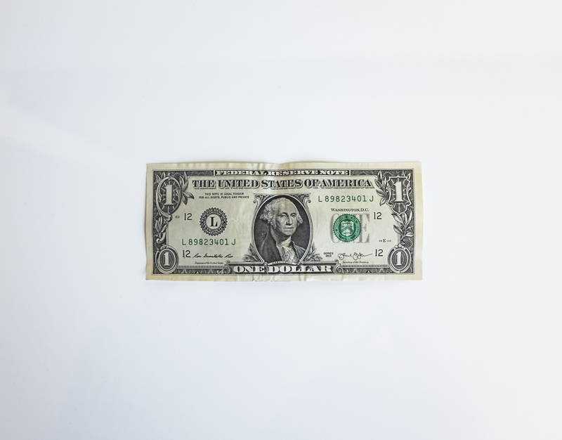one dollar bill representing a low job salary