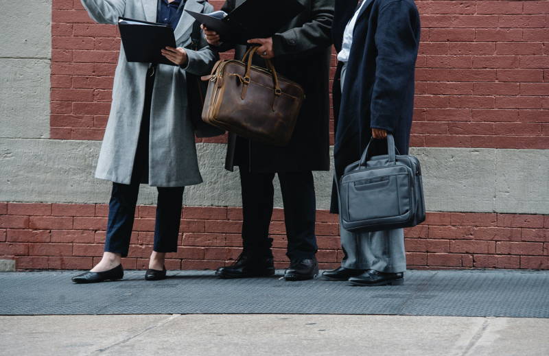 Businesspeople standing on the side of the road
