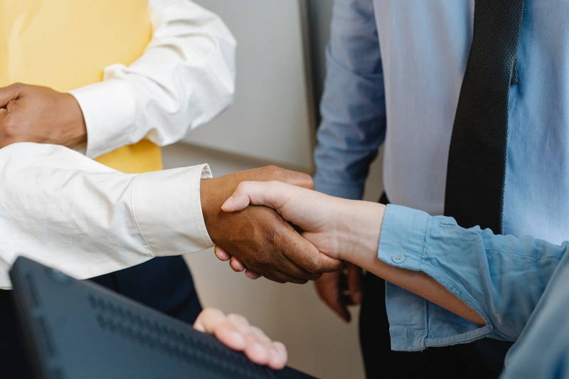 DEI leaders at a tech company shaking hands