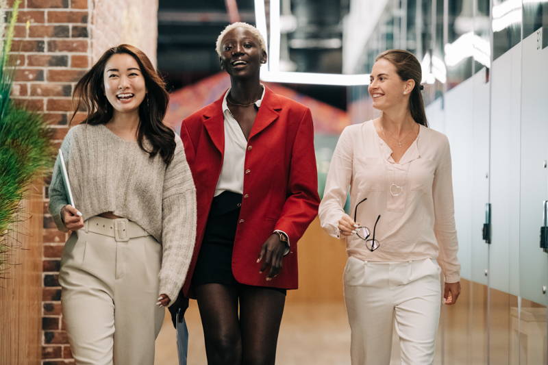 Women walking down a hallway smiling in a women's group