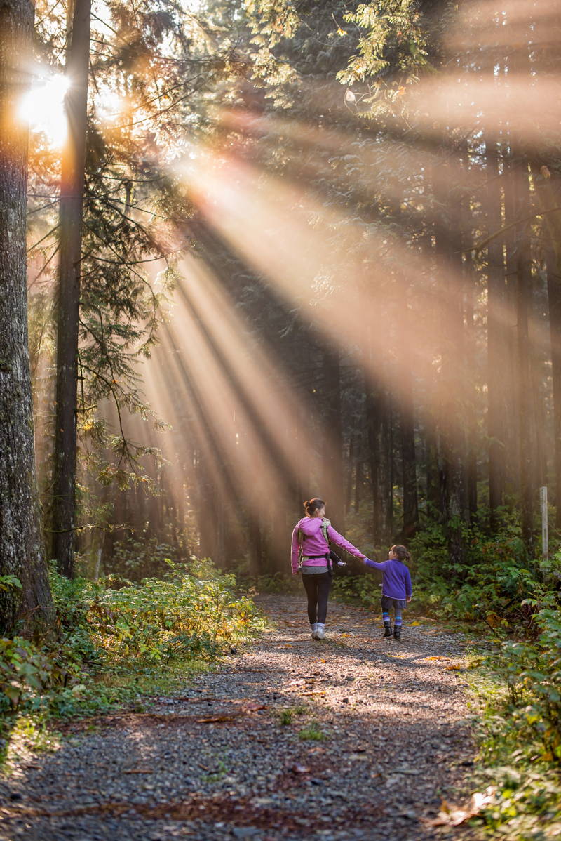 Mom and daughter walking in the forest