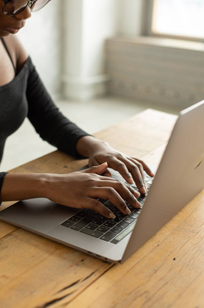 Woman typing a resignation letter email to quit her job