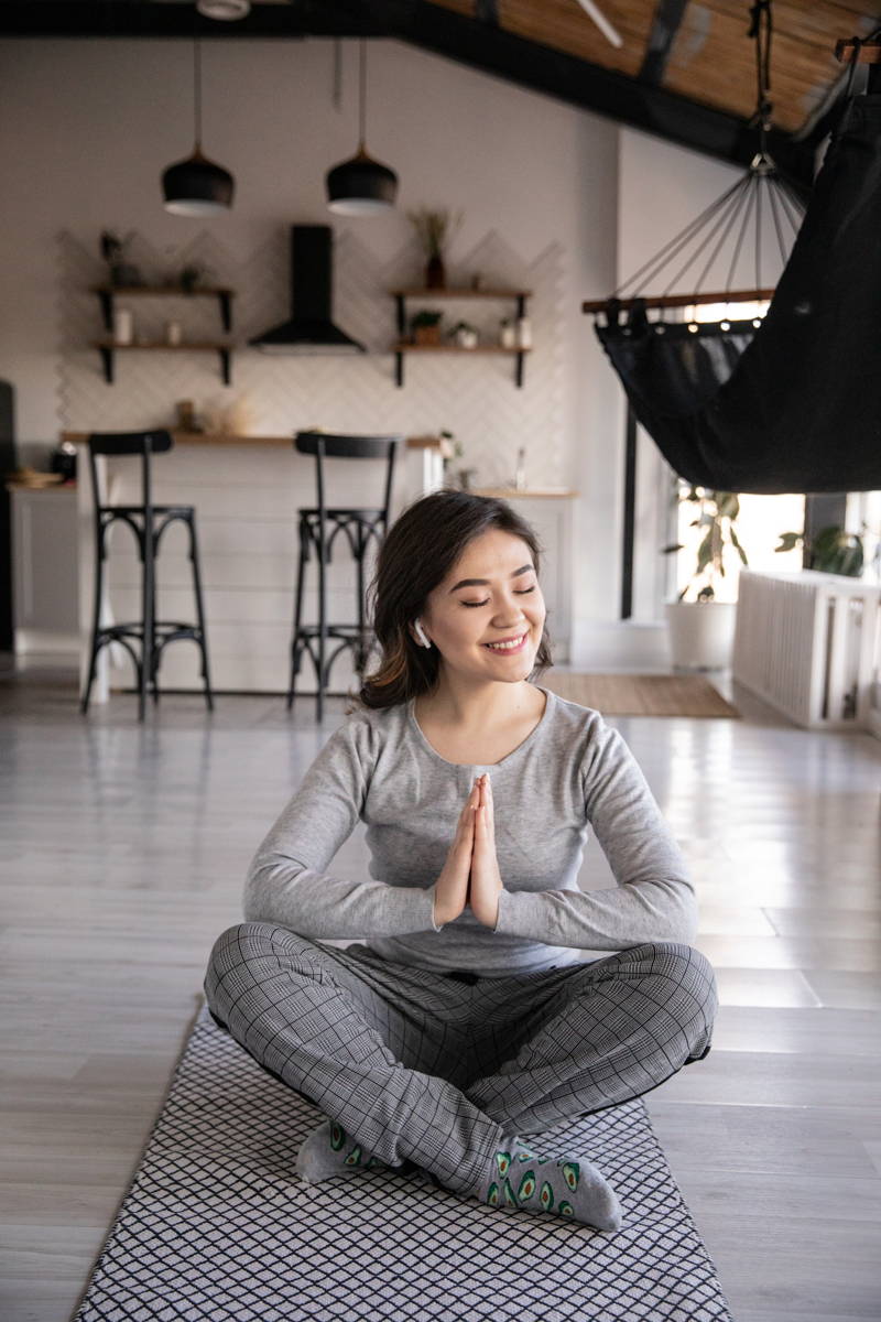 woman doing yoga while working remotely to relieve stress