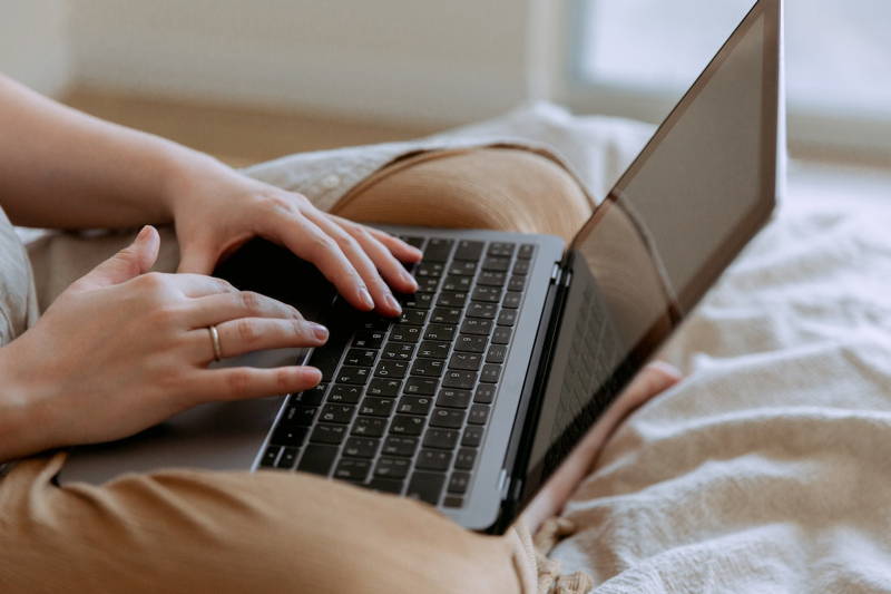 Woman’s hands typing an introduction email on her laptop