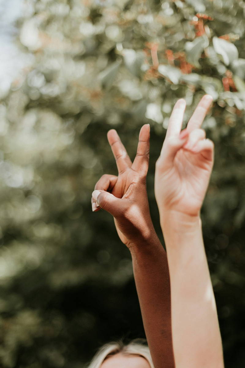 Woman holding up peace sign