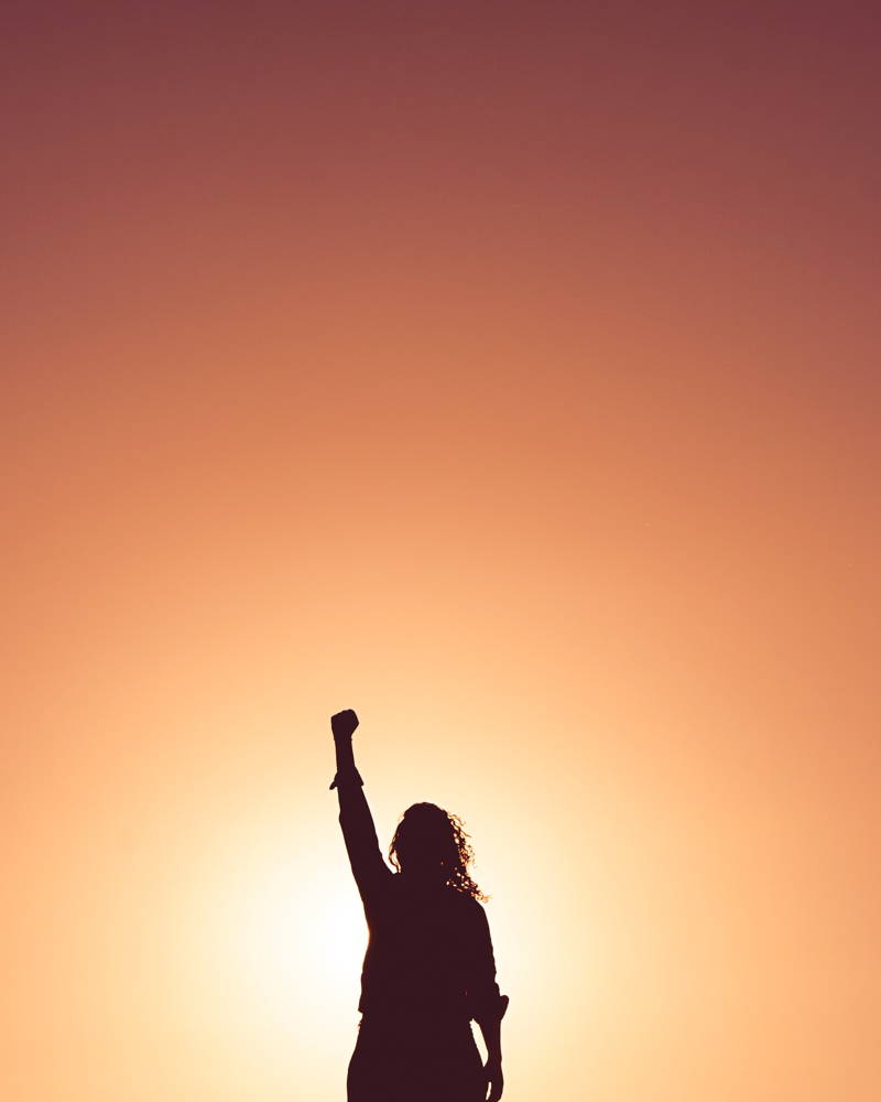 Woman raising her fist into the air